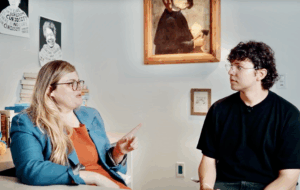 UCLA professor Jaimie Krems conducts an interview with a research participant in an office setting.