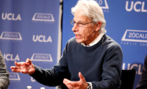 Robert Goldberg, renowned plant biologist and UCLA educator, speaks at a UCLA event with gesturing hands.