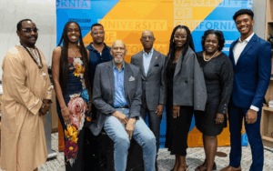 UC Black Alumni Association members and leaders, including Naomi Hammonds, pose together at an event