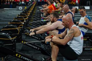 Athletes on rowing machines, competing in a test of endurance.