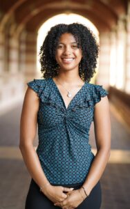 Schroeter, a Bunche Fellow and rising changemaker, poses for a portrait in an archway setting.