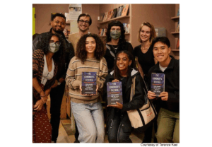 BCS Keel Lab members posing together indoors while holding books or materials