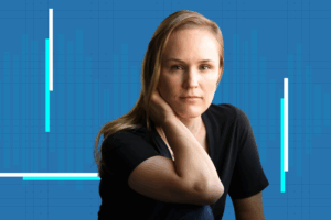 Kate Wassum, UCLA neuroscience researcher, poses against a blue background with neon vertical lines for a podcast about